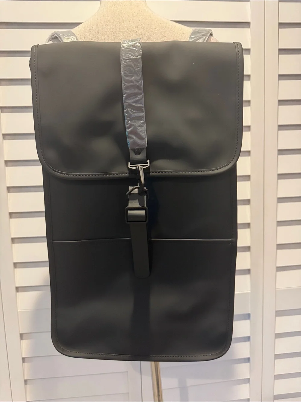 Rains NWT Black Matte Backpack, W/external Back phone pocket, fits a 15” laptop.